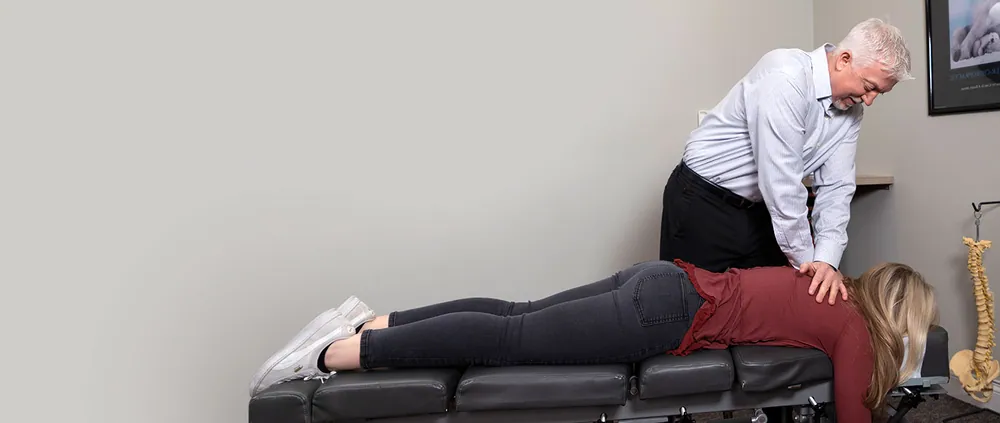 Dr. Mark Arsenault adjusting a patient’s back