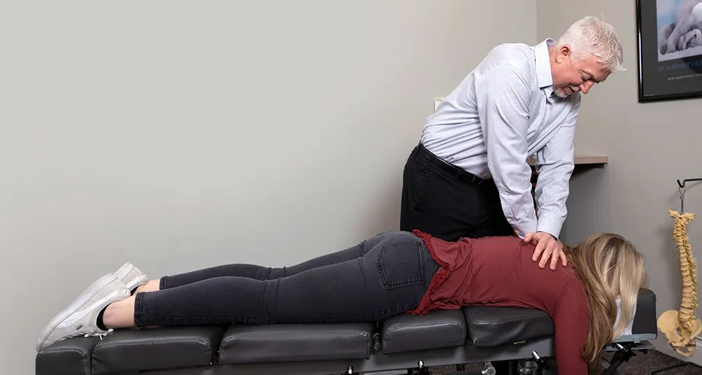 Dr. Mark Arsenault adjusting a patient’s back
