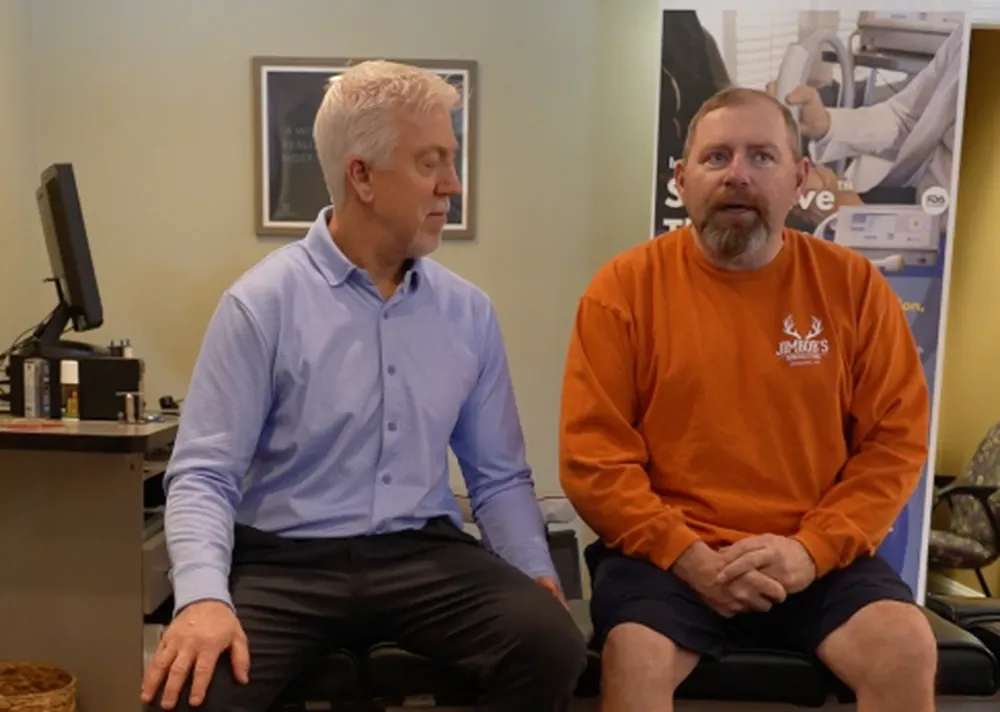 Dr. Mark Arsenault talking with a patient