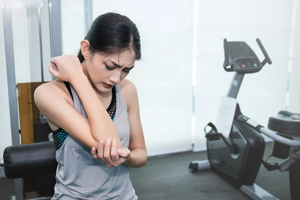 woman having a arm pain after working out
