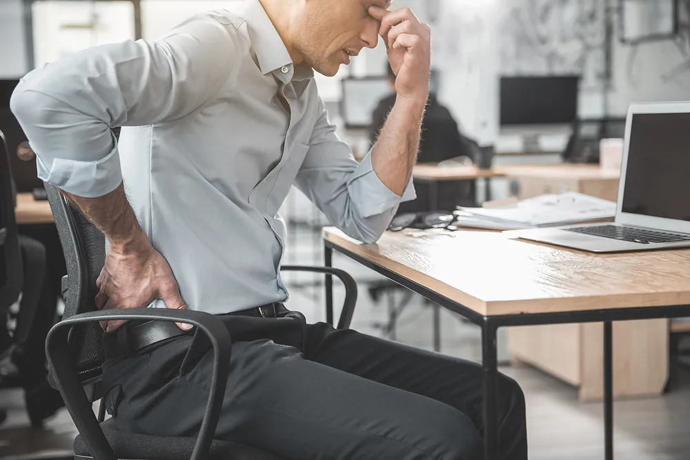 man having a lower back pain after his work