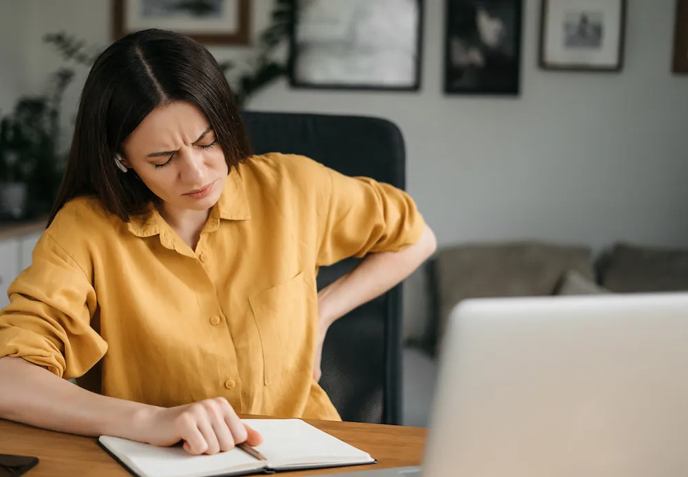 woman having a lower back pain from lower poor posture