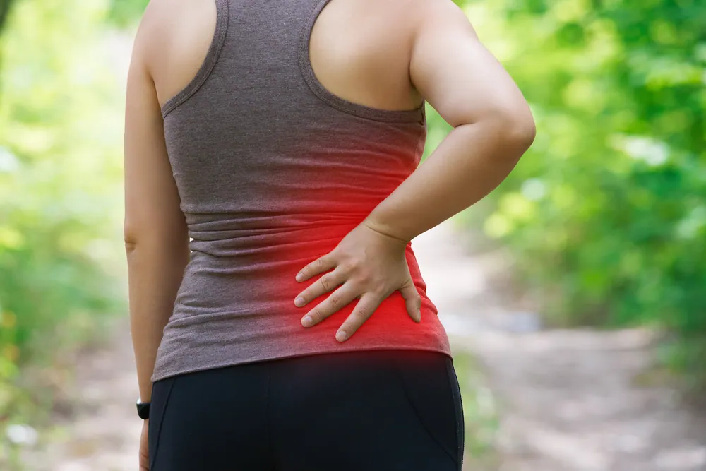 woman having a lower back pain after walking