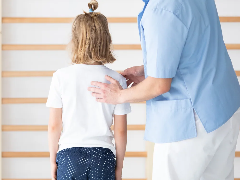 chiropractor checking the back of the young lady